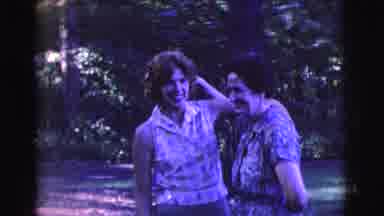Clarkdale Arizona (1961): Two Women Walking In Garden In Daylight Are Hugging Each