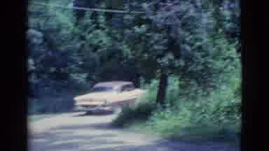 Clarkdale Arizona (1961): Brown And Yellow Car Stops By Green Bush Then Drives