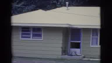Clarkdale Arizona (1961): A Light Green Home With Green Grass In The Yard
