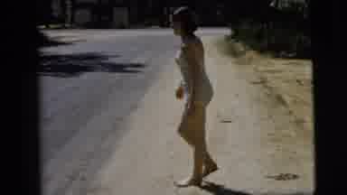 Camden New Jersey (1962): Young Woman Walks Backwards Slowly On A Sandy Patch At