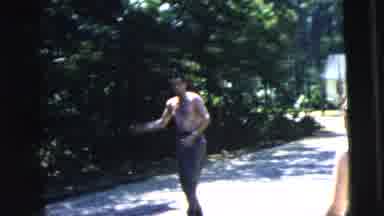Camden New Jersey (1962): Shirtless Man Plays Catch With Young Woman Wearing