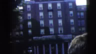 Camden New Jersey (1962): Woman Wearing Black Skirt Walks Around Black Car On A
