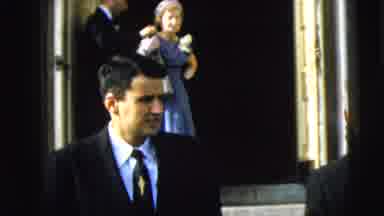 Camden New Jersey (1962): Man Leaves Lady Behind As She Puts Her Jacket On After