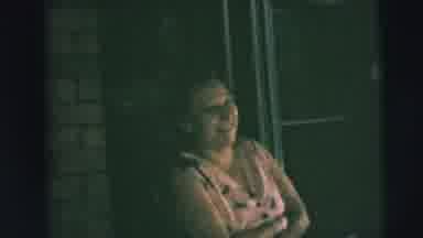 Camden New Jersey (1962): Woman In Pink Dress Stands Laughing On Porch While Man