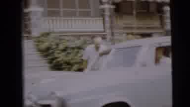 Camden New Jersey (1962): Elderly Woman Standing Next To An Older Car With One Man