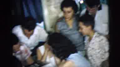 Camden New Jersey (1962): A Group Of People Looking Through A Photo Album At A