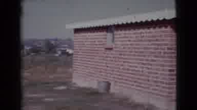 Cottonwood Arizona (1964): A Red Brick House In A Open Space With A Window On One