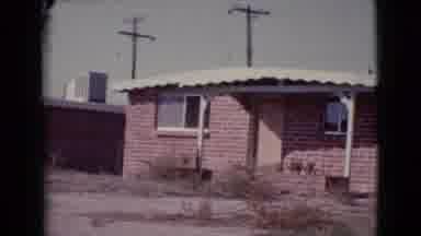 Cottonwood Arizona (1964): A Small Red-Brick House With A White Flat Roof Sits In