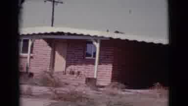 Cottonwood Arizona (1964): A Red Brick House In Open Space With Door And Windows
