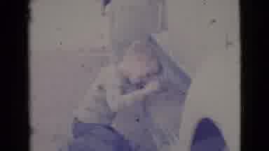Cottonwood Arizona (1964): A Little Boy Playing With Dirt On A Bench