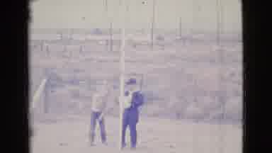 Cottonwood Arizona (1964): Two People In A Field Standing Near A Wooden Fence