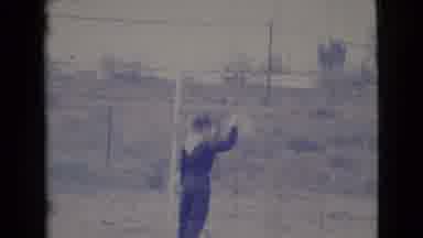 Cottonwood Arizona (1964): A Boy In A Uniform Bouncing A Ball In A Courtyard