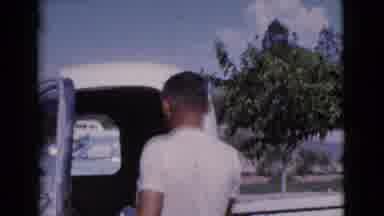 Cottonwood Arizona (1964): A Man Wearing A White Shirt And Blue Jeans Getting Into