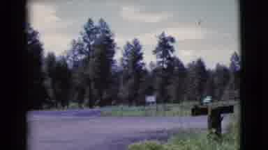 Cottonwood Arizona (1964): Person Driving A Car Up To A Gathering In Front Of A