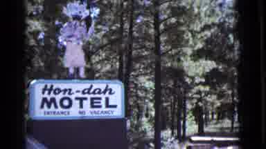 Cottonwood Arizona (1964): A Car Is Passing By A Sign Board Of A Motel On Side Of