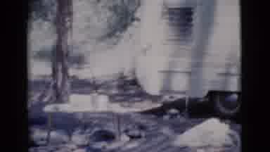 Cottonwood Arizona (1964): Man Wearing Blue Jeans Stands In Front Of Camper On A