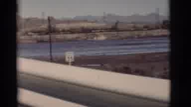 New Mexico (1964): A Vehicle Passes Over A Bridge With River And Mud Flats Crossed