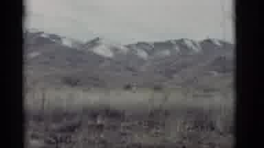 New Mexico (1964): Line Of Mountain Tops In The Background With Grassy Plains