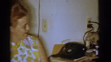 Clarkdale Arizona (1966): Woman Wearing A Yellow Floral Shirt Smiling As A Child
