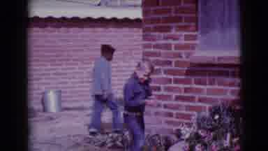 Clarksdale Arizona (1968): Boy In Jacket Playing Outside Near Garden