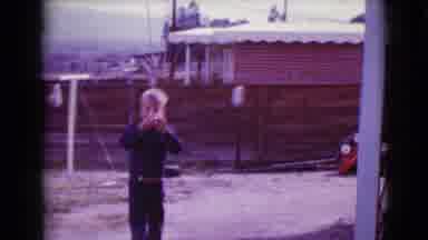 Clarksdale Arizona (1968): Young Blonde Boy Playing Outside In A Backyard With