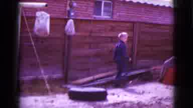 Clarksdale Arizona (1968): A Boy Plays Around A Yard Near A Wooden Fence Near A