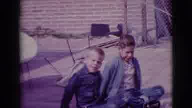 Clarksdale Arizona (1968): Two Children In Denim Outfits Sitting On A Paved Patio