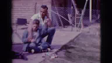 Clarksdale Arizona (1968): Father Teaches Son How To Use New Toy Outside In Their
