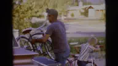 Clarksdale Arizona (1968): A Man Removes A Bicycle From A Truck And A Boy Attempts