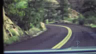 Grand Canyon Arizona (1972): A Person Driving Down Street Surrounded By The Forest