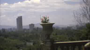 Mexico City (1973): A City With Large Concrete Buildings In The Background