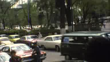 Mexico City (1973): Multiple Cars Driving Down Busy Streets Of A City During The