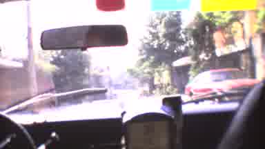 Mexico City (1973): A Car Driving On A Tree-Lined Street Then An Image Of A Great