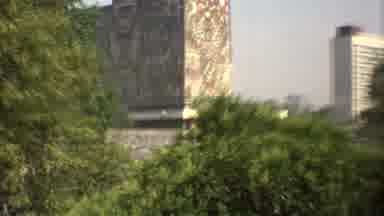 Mexico City (1973): Zooming In On A Brick Building In The Distance With A Face
