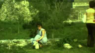 Yucatan Mexico (1973): A Woman Sits In The Grass As Another Woman Walks Around A