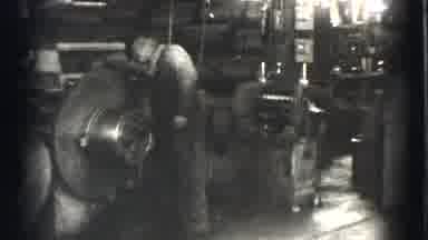 Cleveland Ohio USA (1939): Men Working In A Factory With A Big Piece Of Spinning