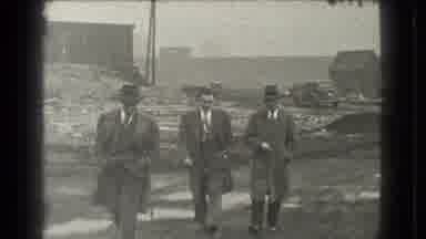 Cleveland Ohio USA (1939): Three Men Wearing Grey Coats Walk Toward Camera On A