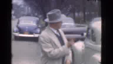 Cleveland Ohio USA (1939): A Man In A Grey Top Hat And A Beige Coat Gesturing Past