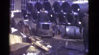 Cleveland Ohio USA (1939): A Group Of Men Working In A Factory While One Rides