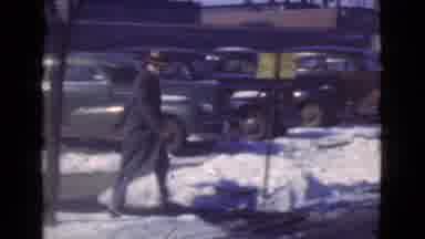 Cleveland Ohio USA (1939): Man In Nice Clothes And A Hat Jogs Across The Street In