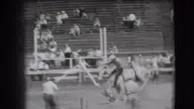 Denver Colorado USA-1941: Man Riding Bucking Horse At Rodeo With Crowd Watching