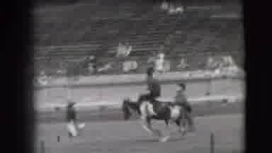 Denver Colorado USA (1941): In A Large Stadium Several Men Ride Horses One Man Has