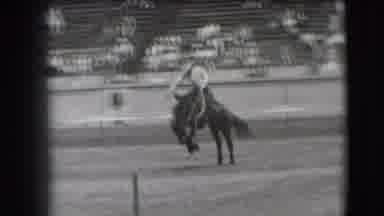 Denver Colorado USA (1941): Man Competing At A Rodeo Tries To Hold On To Horse