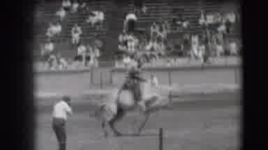 Denver Colorado USA (1941): Cowboy On Bucking Horse Tries To Hang On And Complete