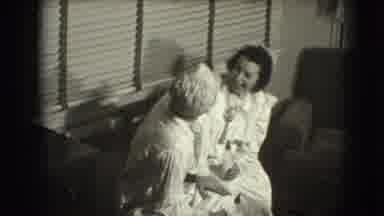 Joliet Illinois USA (1941): Woman Wearing White Dress And Hat Looks At Couple