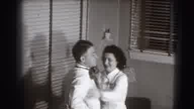 Joliet Illinois USA (1941): Woman Fixing Her Husband's Tie At Home Gift Her Son