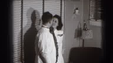 Joliet Illinois USA (1941): Man Wearing White Shirt Sits Down Next To Woman