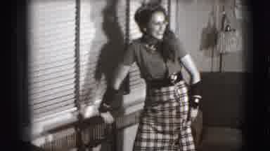 Joliet Illinois USA (1941): Young Happy Woman In A Skirt Raises It Slightly While