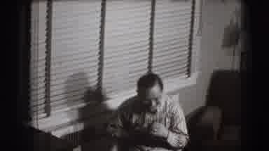 Joliet Illinois USA (1941): Man In A Bow Tie Sits Down And Laughs For The Camera