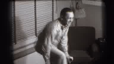 Joliet Illinois USA (1941): Man Sits Awkwardly On A Chair Backwards And Puts His